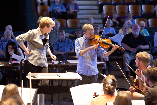 Composer Andrew Norman demonstrates a technique to Cabrillo Festival string players, in rehearsal for his ambitious work 'Play.' Photo by rr jones.