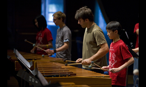 Percussionist Svet Stoyanov warms up with a young colleague before the Free Family Concert. Photo: rr jones