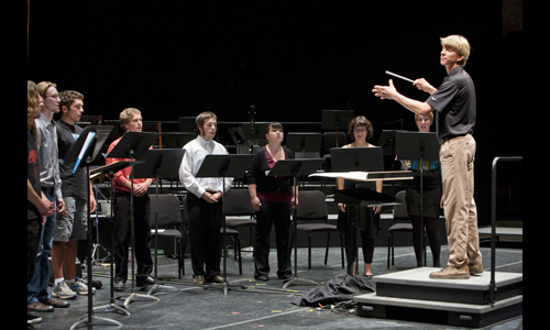 Student Staffer Robert Marshall leads Ensemble members in his own choral composition. Photo: rr jones