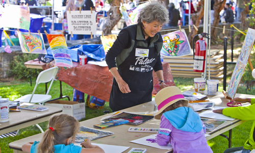 Longtime Creativity Tent Artist Carmen Leon leads a painting and drawing worshop at the Church Street Fair. Photo by rr jones.