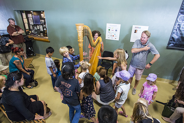 Principal harp Nuiko Wadden invites kids to get up-close during the Tour of the Orchestra. Photo by rr jones.