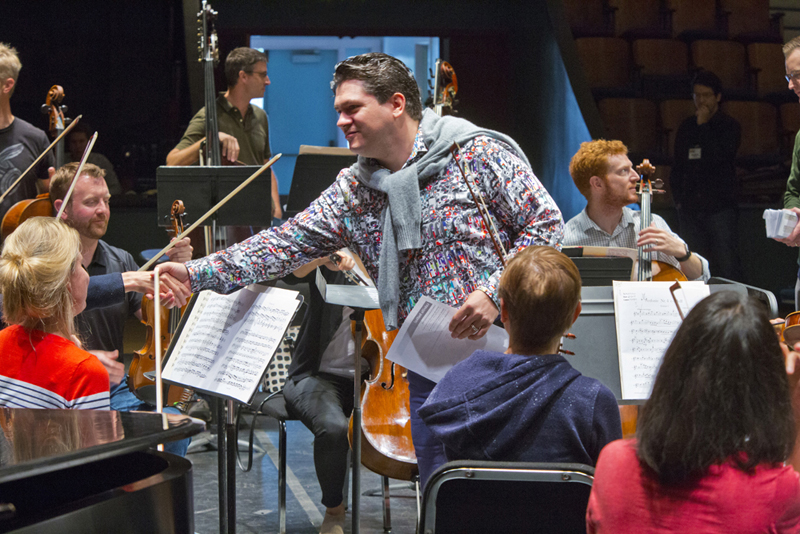 Cristi greets Festival Orchestra musicians during his inaugural season. photo by rr jones