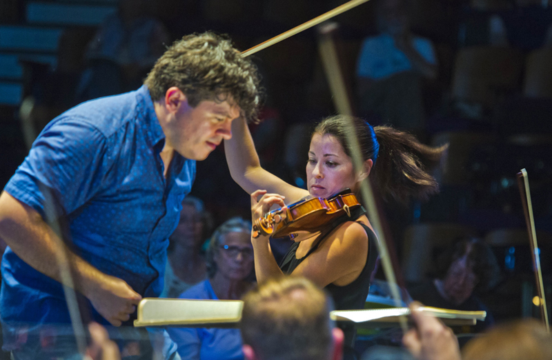 Crist and violinist Jennifer Frautshi in rehearsal. photo by rr jones