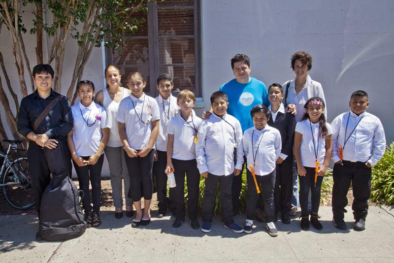 Cristi meets with the young El Sistema musicians from Gault Elementary following their performance at the Church Street Fair. photo by rr jones
