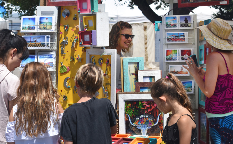 An artisan engages with customers at the Church Street Fair. photo by rr jones
