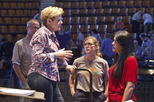 Marin Alsop talks to assistant Alexandra Arrieche as composer TJ Cole looks on. Photo by rr jones.