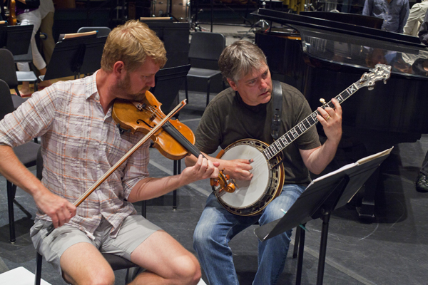 Concertmaster Justin Bruns and Bela Fleck refine a section of Fleck's banjo concerto. Photo by rr jones.