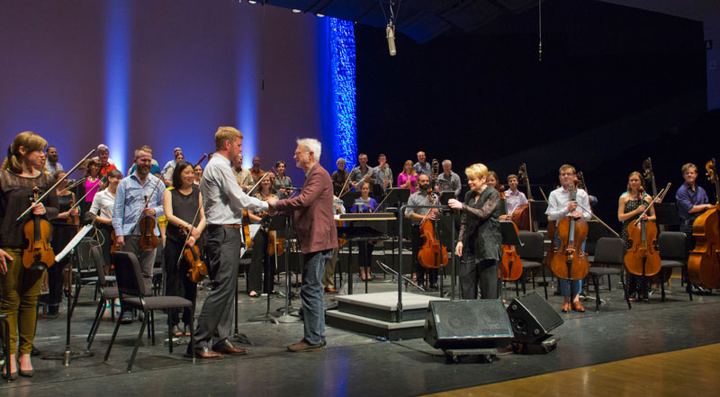 Marin Alsop and John Adams congratulate Concertmaster Justin Bruns, 2016, by rr jones.