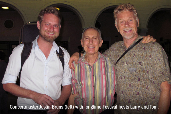 Concertmaster Justin Bruns (left) with longtime Festival hosts Larry and Tom.