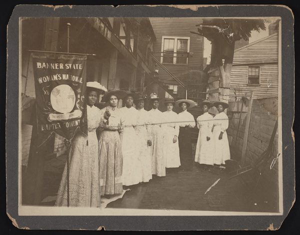 Black suffragists with banner